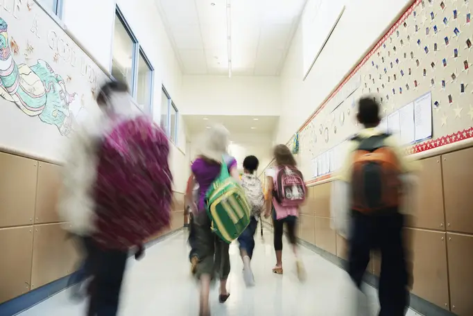 A group of students walking into a hallway
